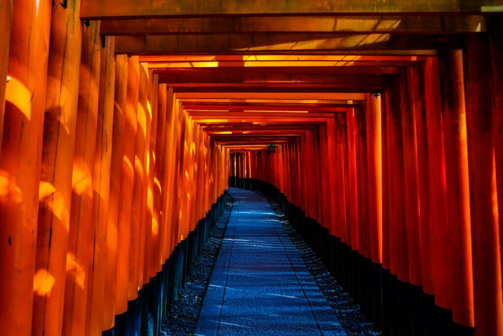 A tunnel of red torii gates line a pathway at Fushimi Inari in Kyoto