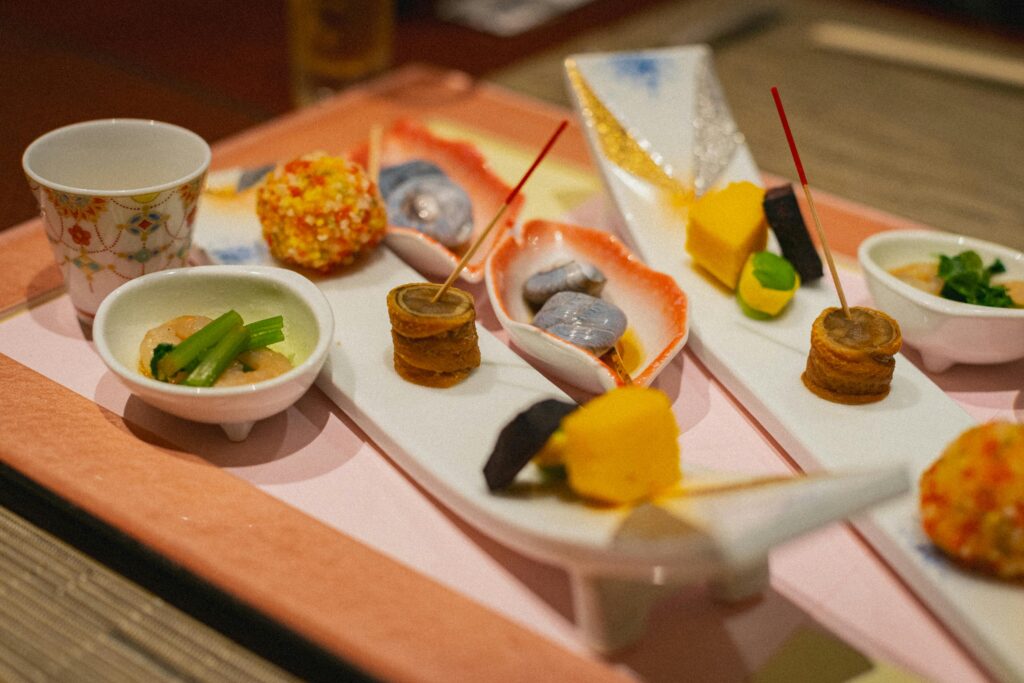 An elaborate Kaiseki meal featuring a variety of seasonal ingredients, artfully presented on individual dishes.