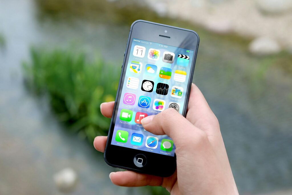 A person searches through their apps on their smartphone