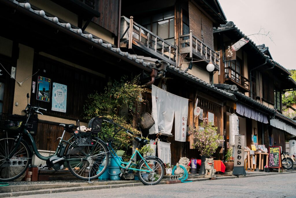 Traditional shops lined with bicycles and signs in Japanese in Kyoto